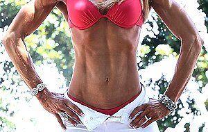 Tall bodybuilder Amazon Nikki shows off her strong body outdoors